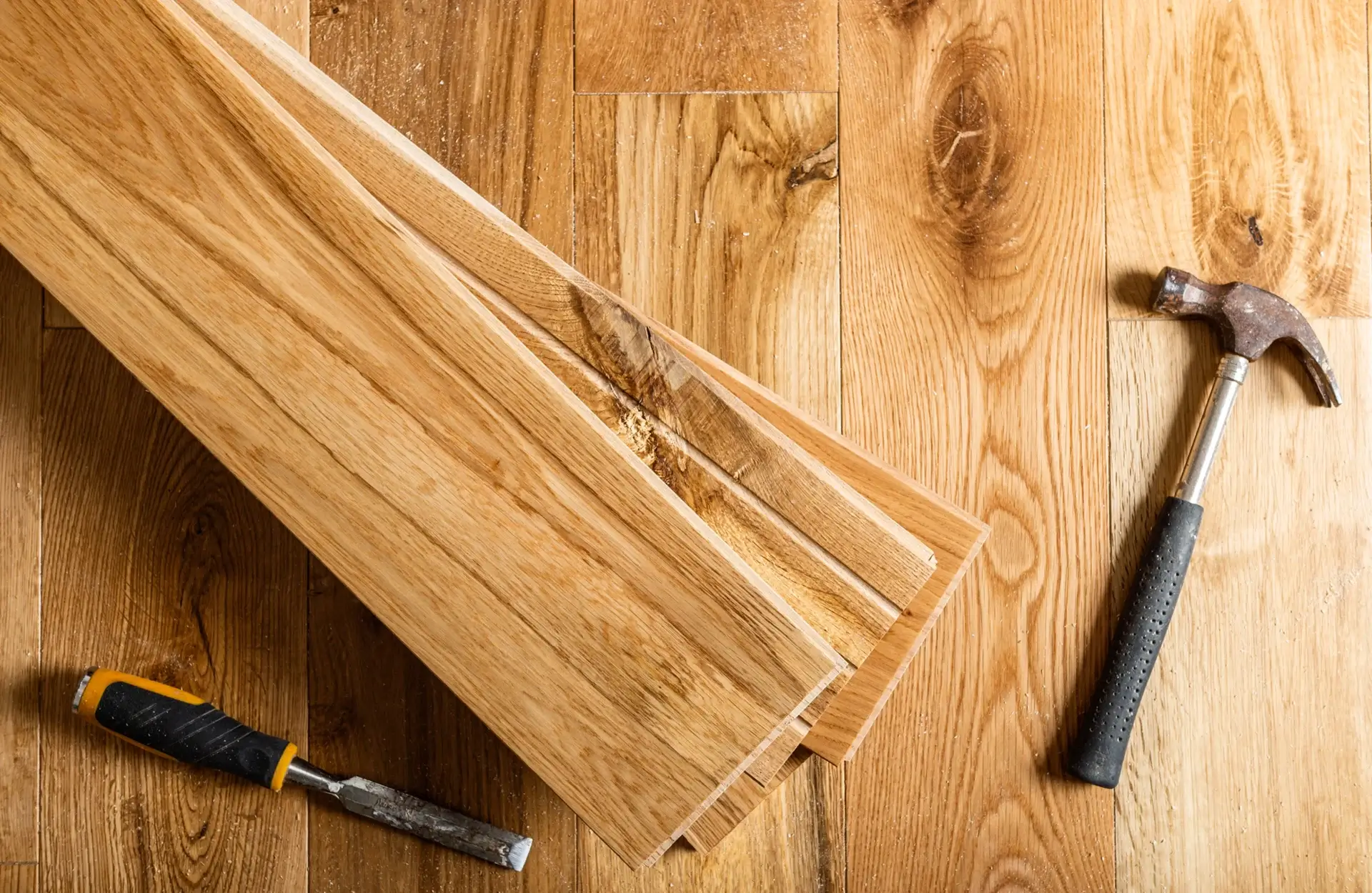 Wooden floorboards with hammer and chisel.